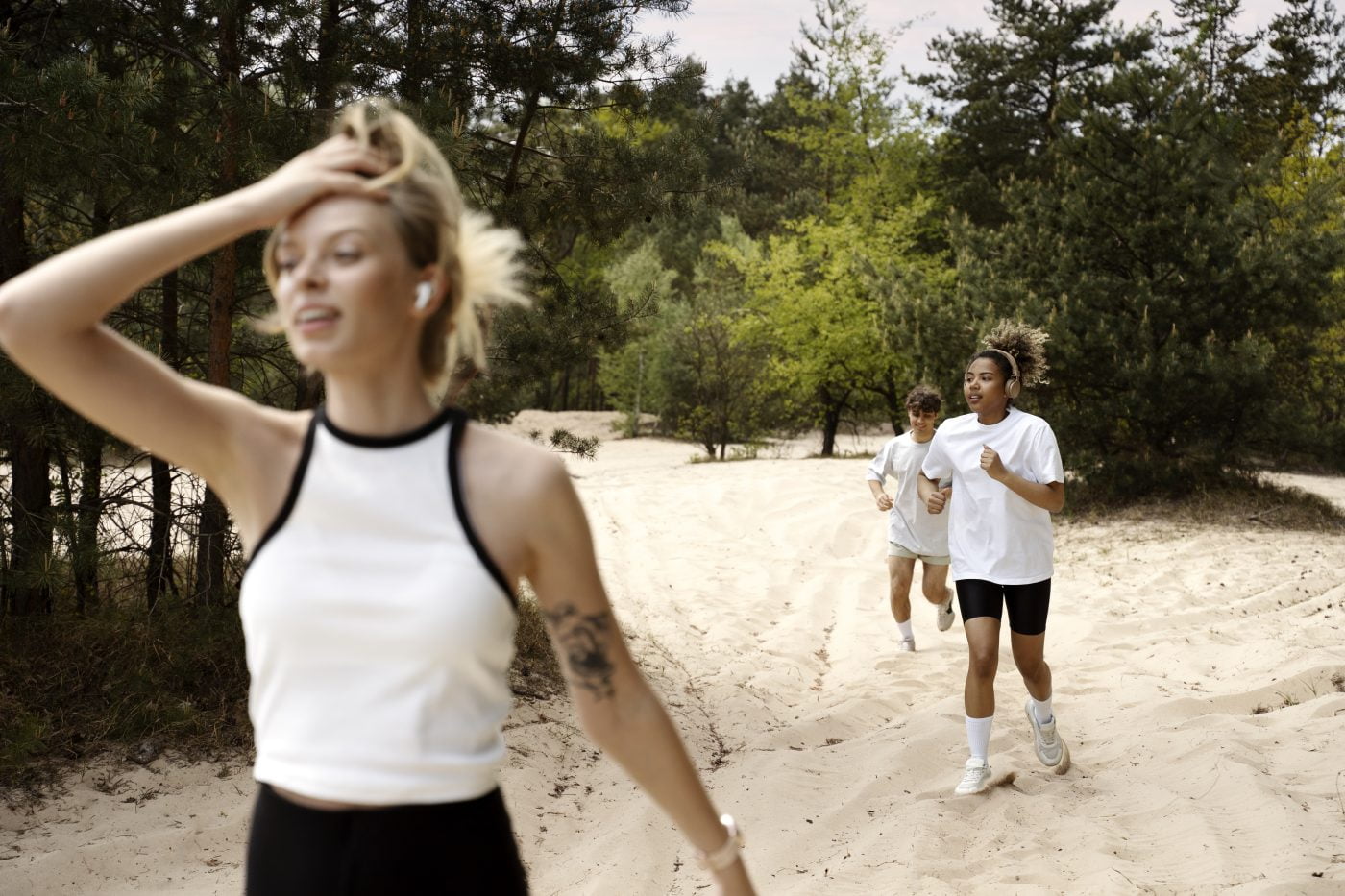 wellso ld side view tired woman running sand